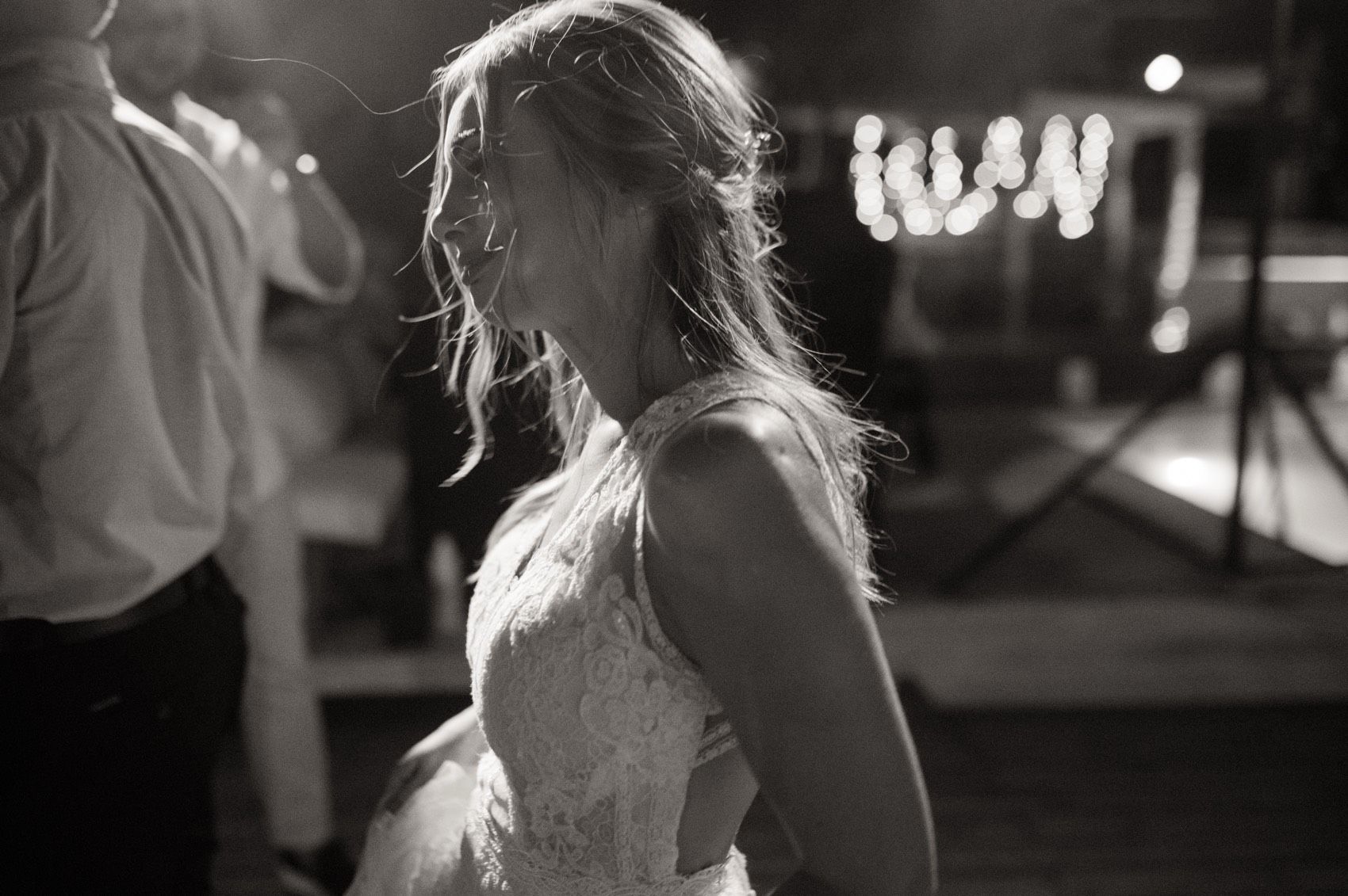 Black and white nighttime photo montage showing silhouettes and light bokeh effects in urban setting.