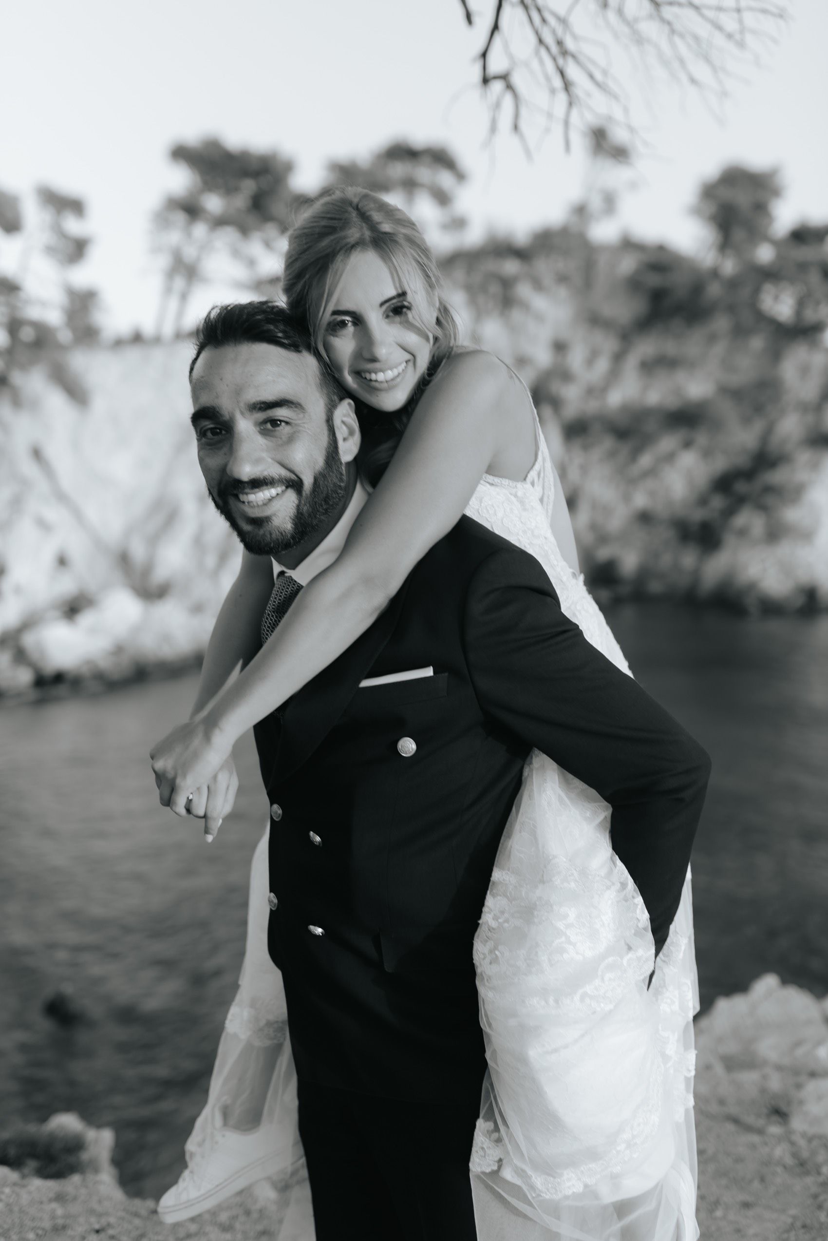 Black and white candid wedding photos showing joyful embraces and laughter between newlyweds outdoors.