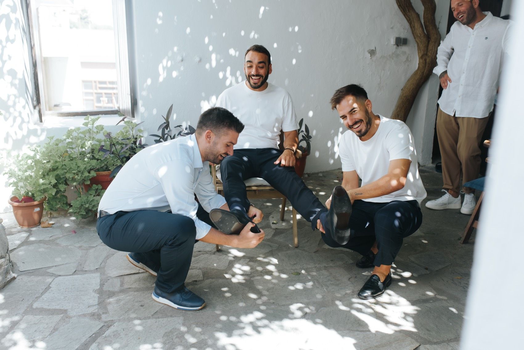 A series of action photos show playful moments between people hanging out and laughing together on a porch.
