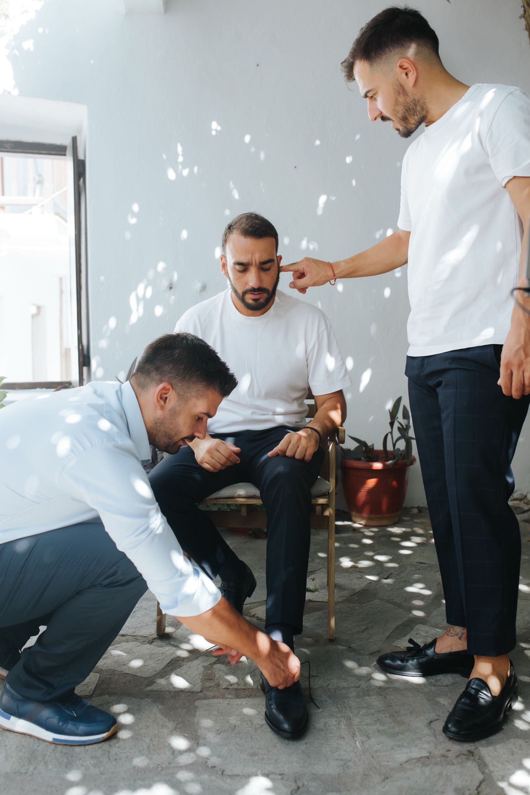 Professional shoe shining service sequence showing five stages of polishing and buffing black leather shoes.