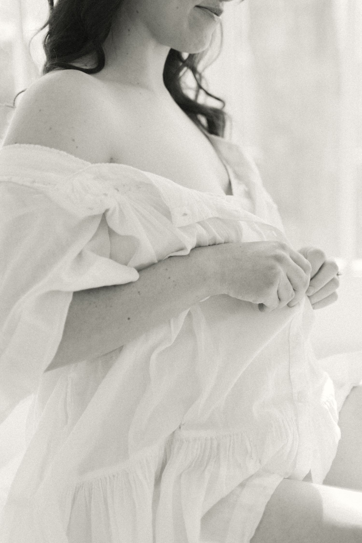 Romantic black and white bridal portrait featuring soft flowing fabric and delicate details.