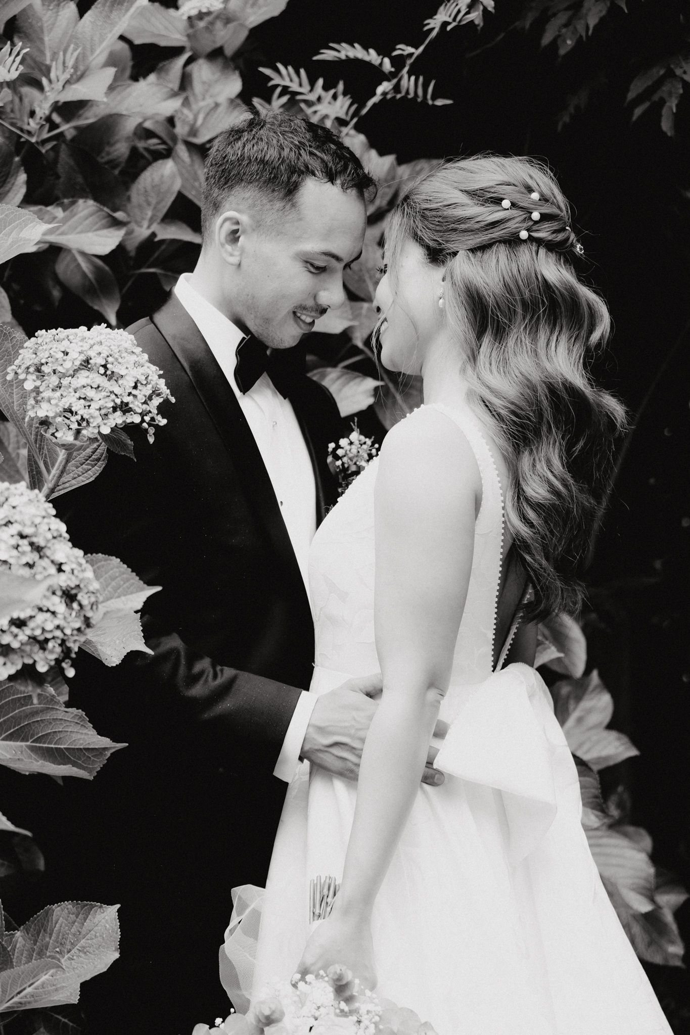 Black and white romantic wedding photo with couple in formal attire captured by Apertured Media Auckland Wedding Photographer.
