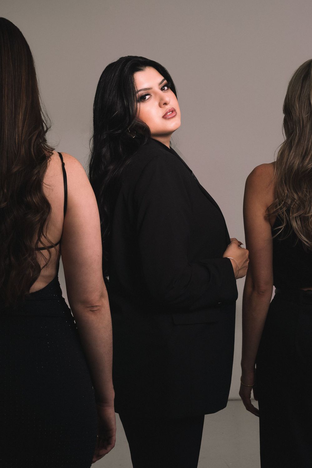 Sydney fashion photographer captures three women in black attire posing against a neutral backdrop in an personal branding session