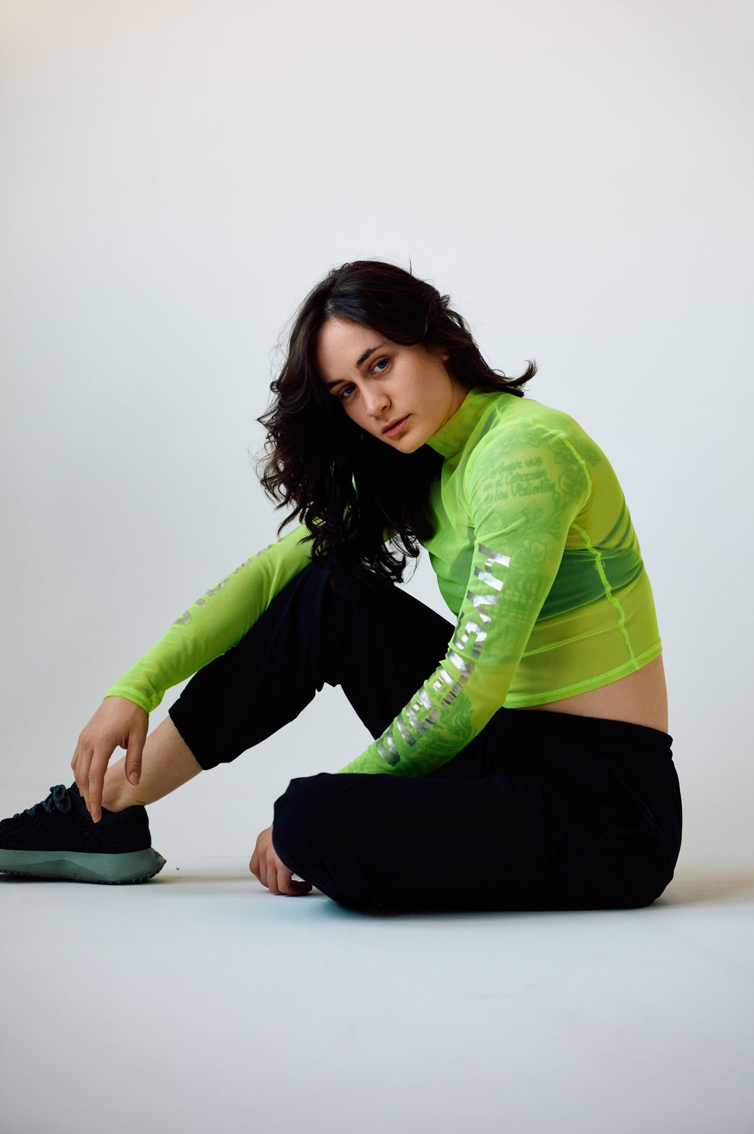 Athletic wear fashion shot featuring neon green crop top jacket.