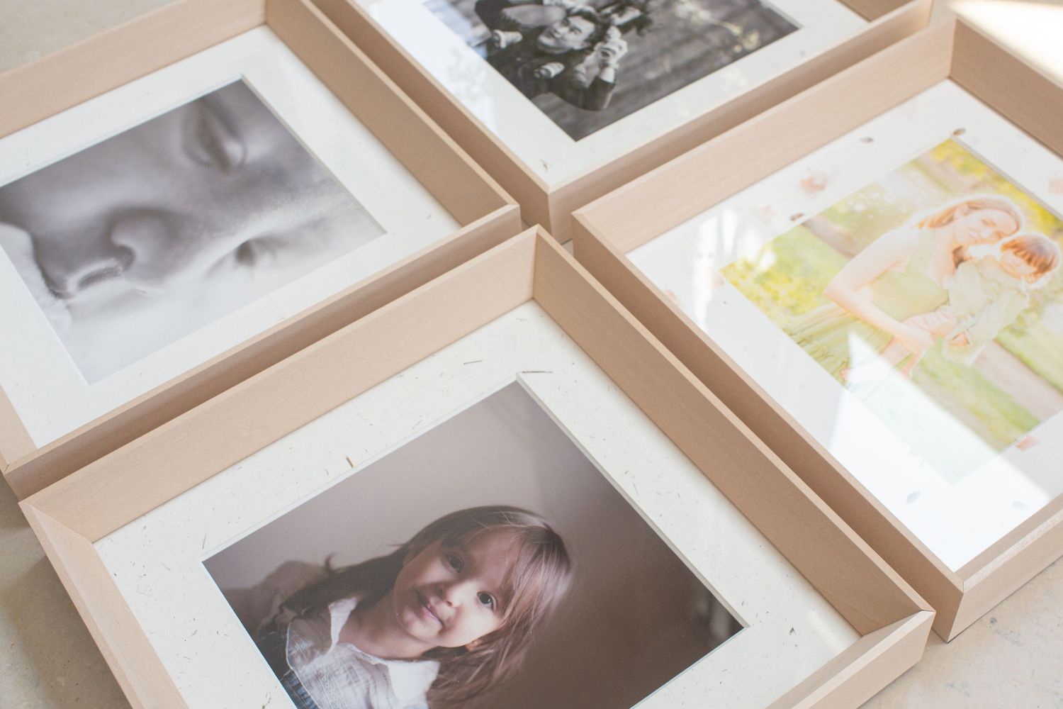 White fabric-bound photo album displaying a collage of memories inside.