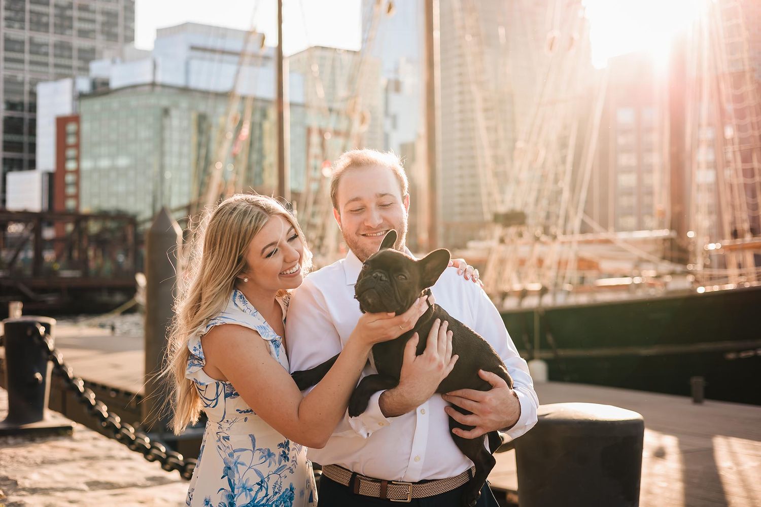 The loving couple chose to bring their adorable puppy to their engagement session at Boston Harbor.