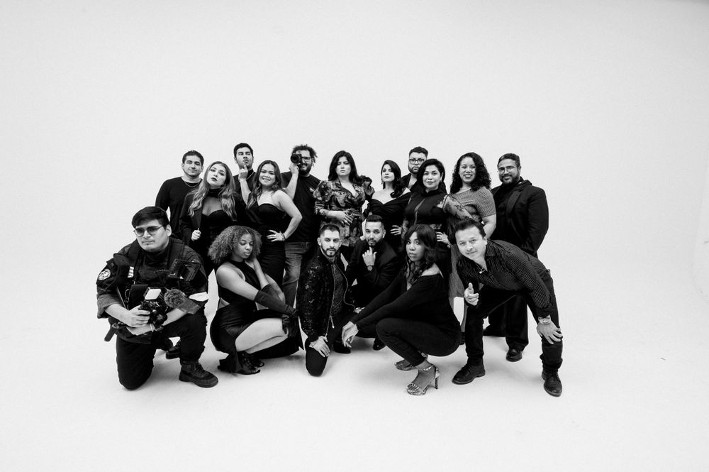 A large group poses together in a black and white photo against a white background.