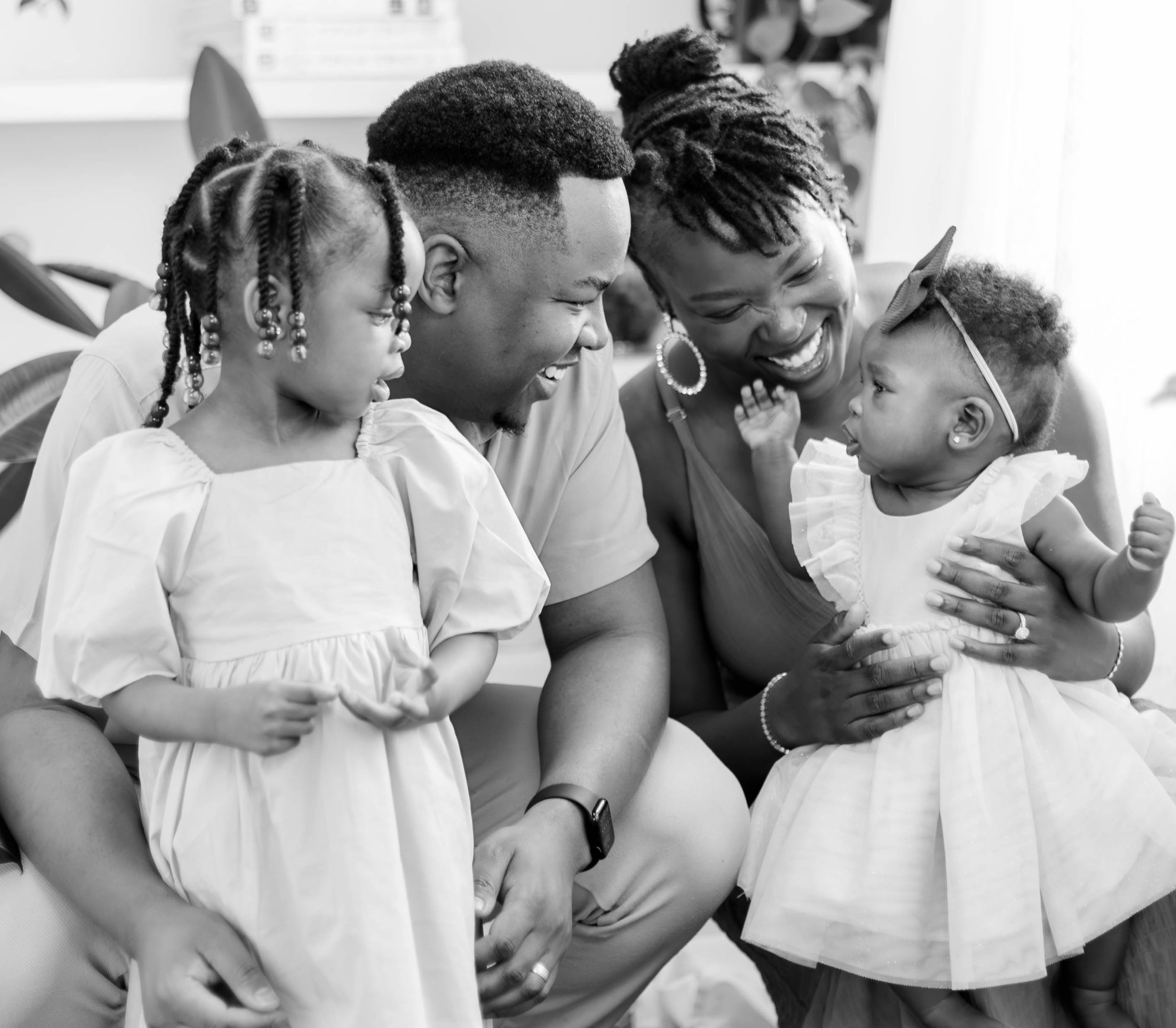A black and white family portrait showing intimate connection between family members.