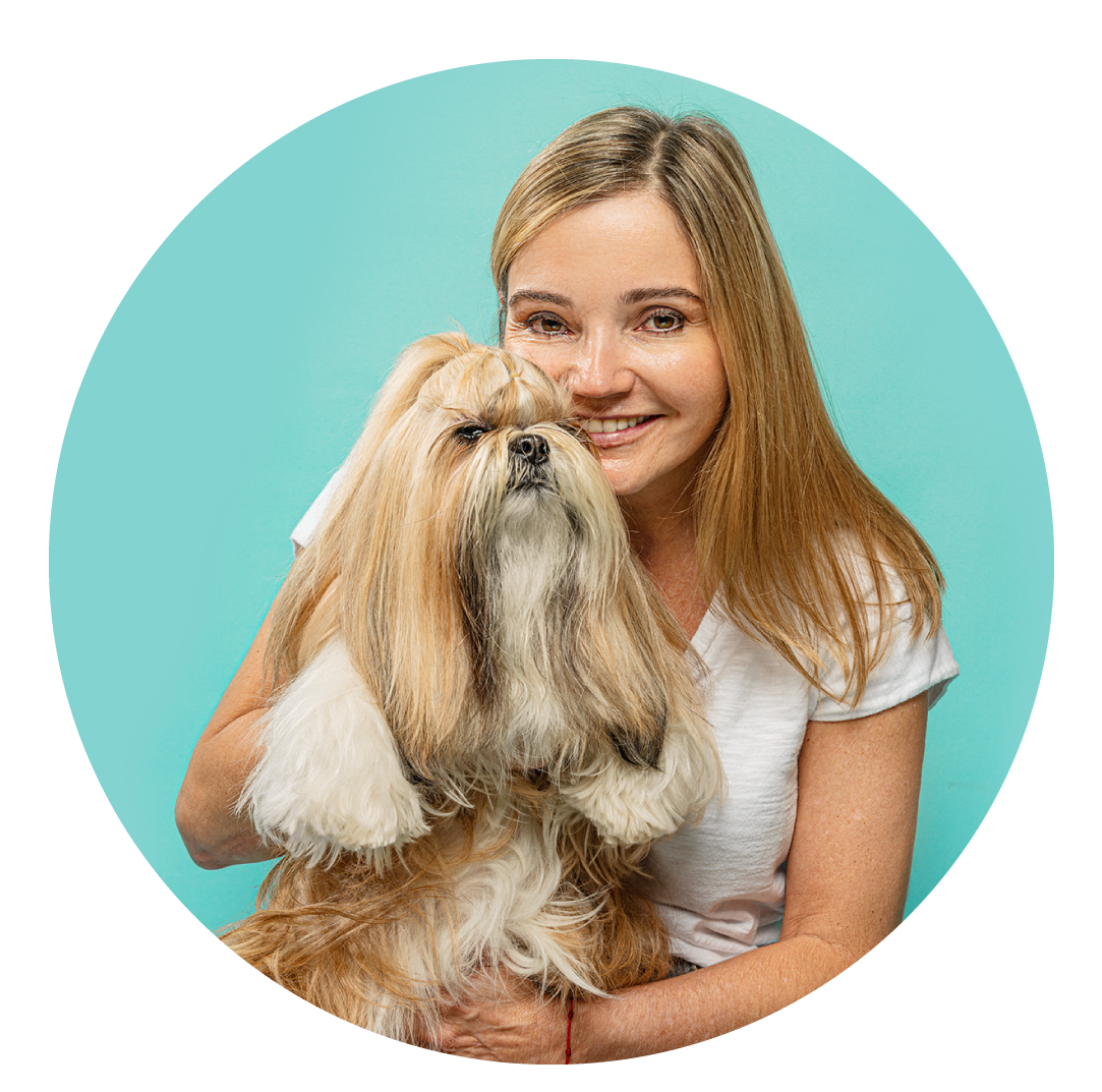 Someone poses with a fluffy Shih Tzu dog against a turquoise background in a circular frame.