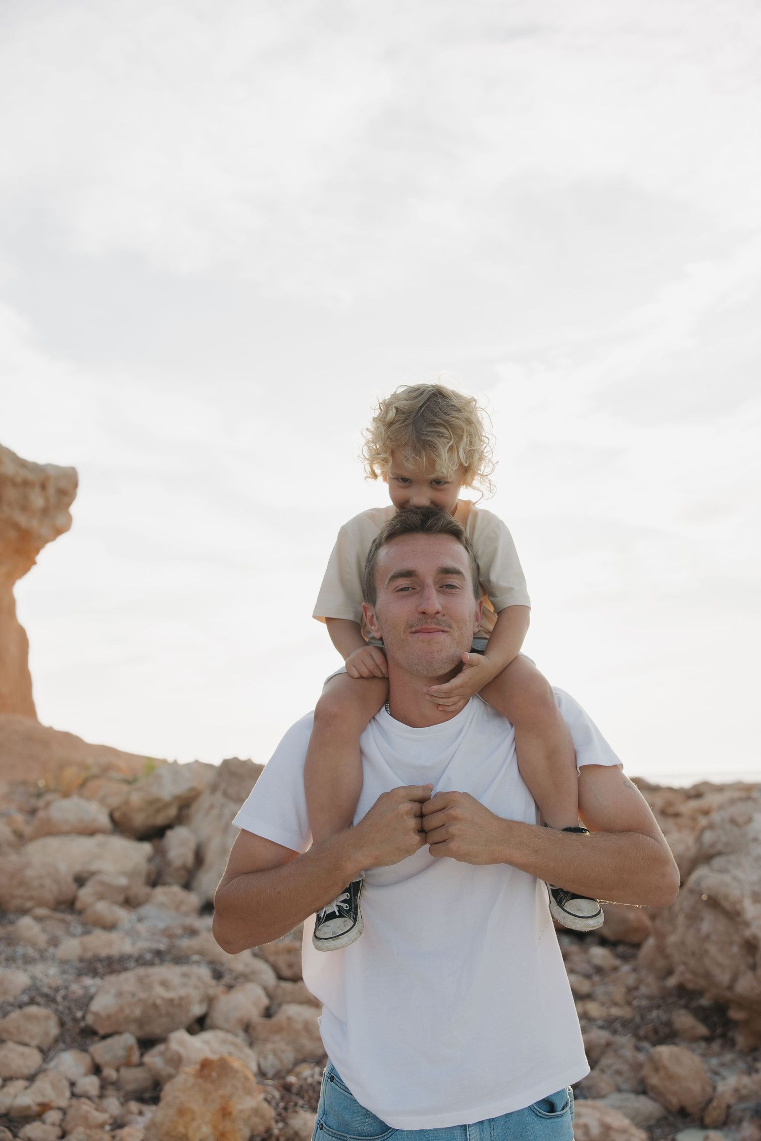 A joyful moment captured on rocky terrain during golden hour.