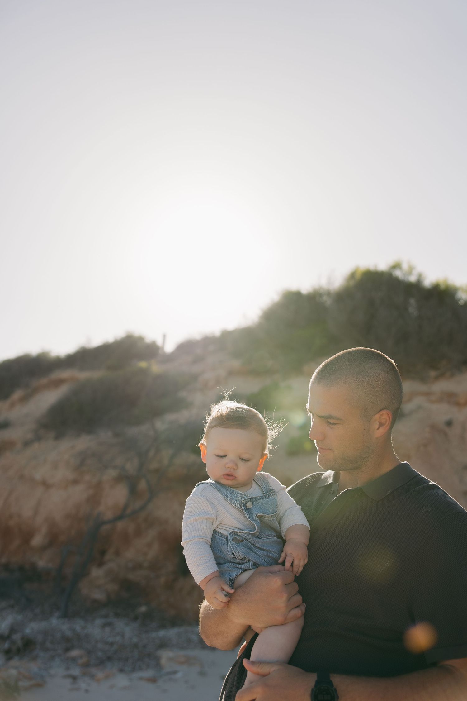 A silhouette portrait against rocky cliffs at golden hour.
