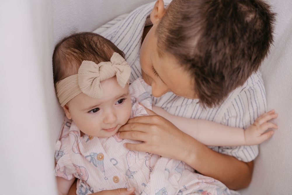 A collection of four tender moments showing a parent comforting a small child in bed.