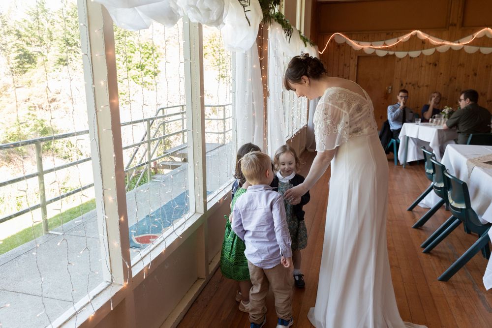 Interior view of decorated event space with windows overlooking outdoor scenery.