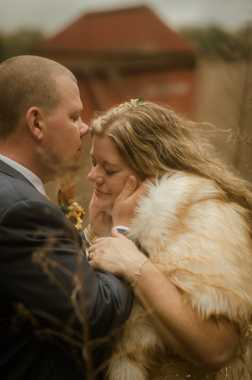 a portrait of a couple just before their wedding day in a field