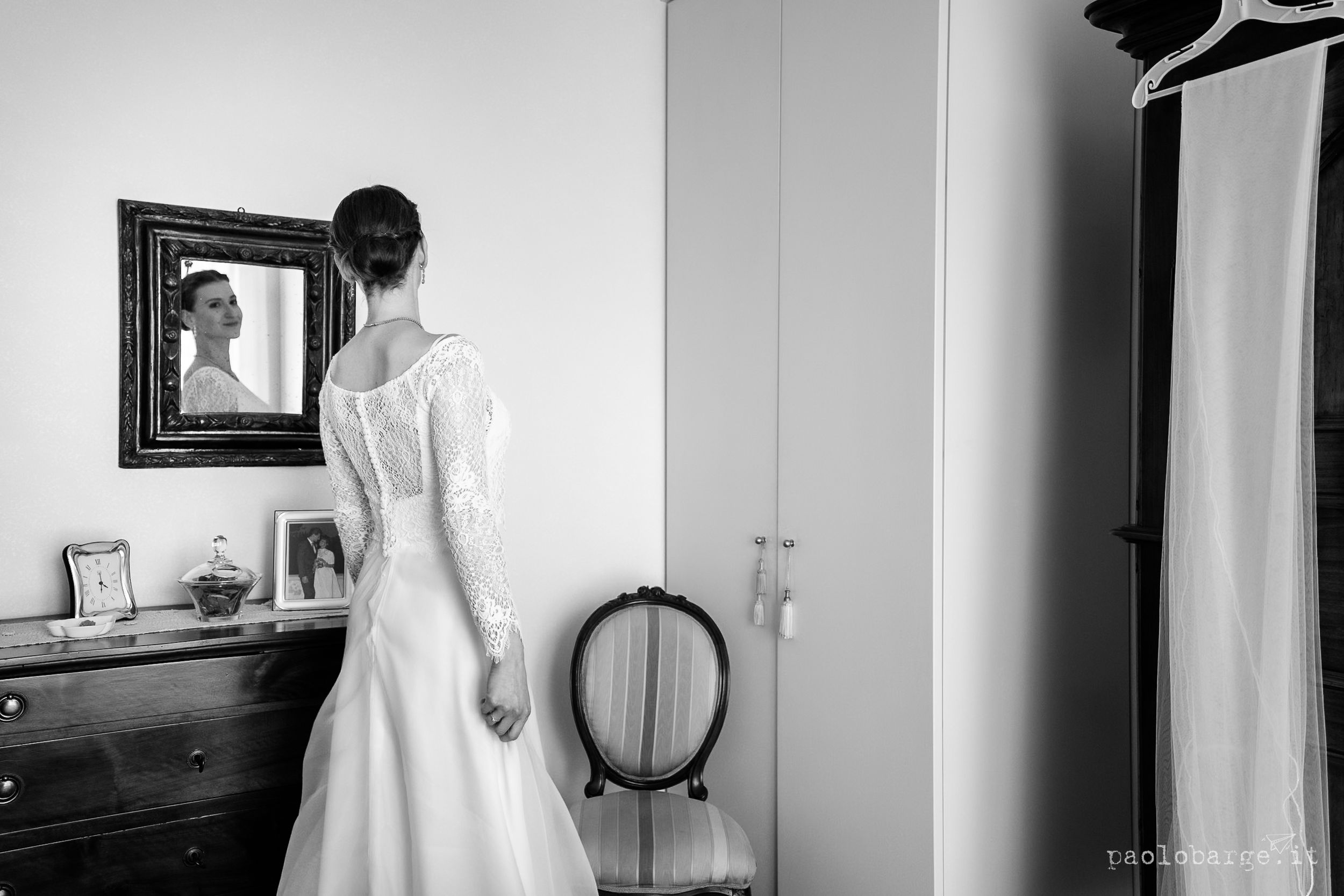 Black and white artistic series showing a woman in white dress near doorways and mirrors creating elegant silhouettes.