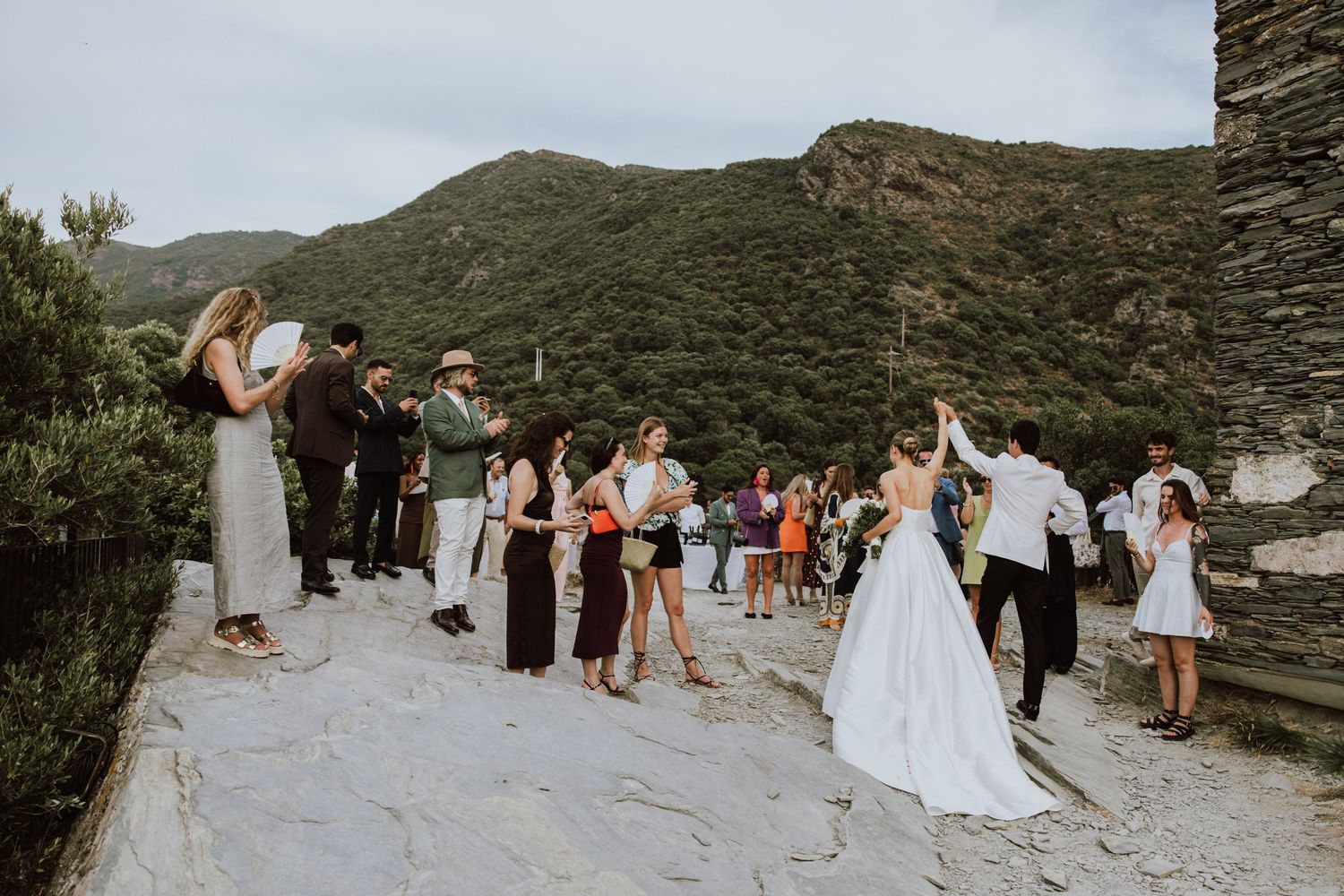 Wedding celebration takes place on a scenic mountain overlook with guests dancing and enjoying the festivities.