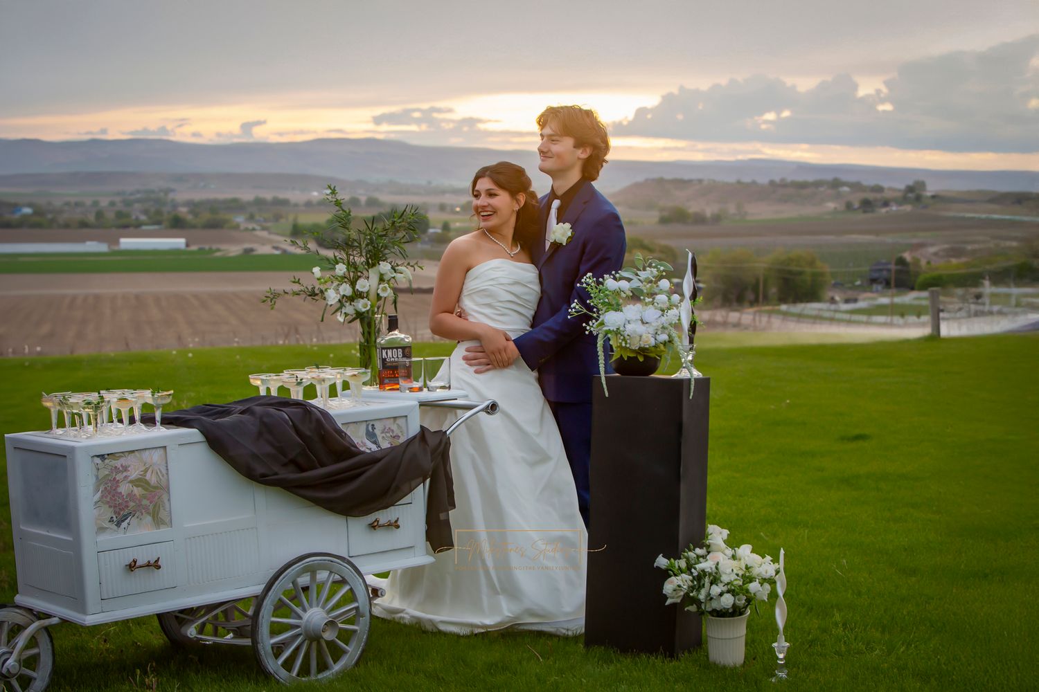 Bride and Groom posing at sunset with Beverage Cart Idaho Tipsy Trailers