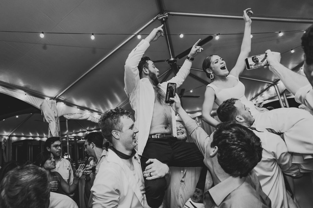 Black and white photographs show an energetic crowd raising their hands and dancing at what appears to be a concert or party.