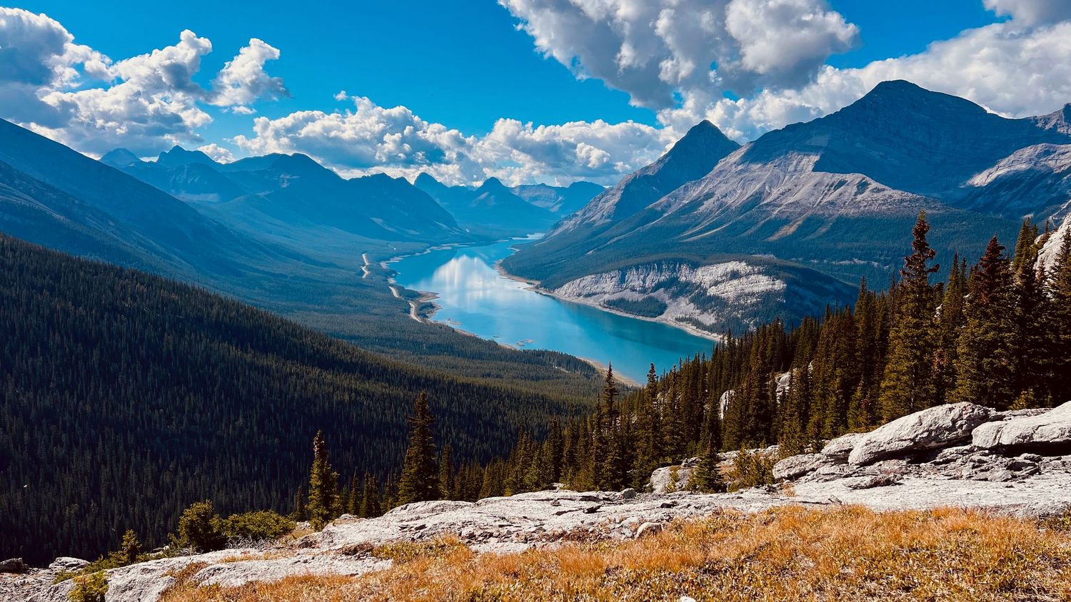 Spray Lakes near Banff National Park in Kananaskis with turquoise waters surrounded by Rocky Mountains under blue sky elopement photography