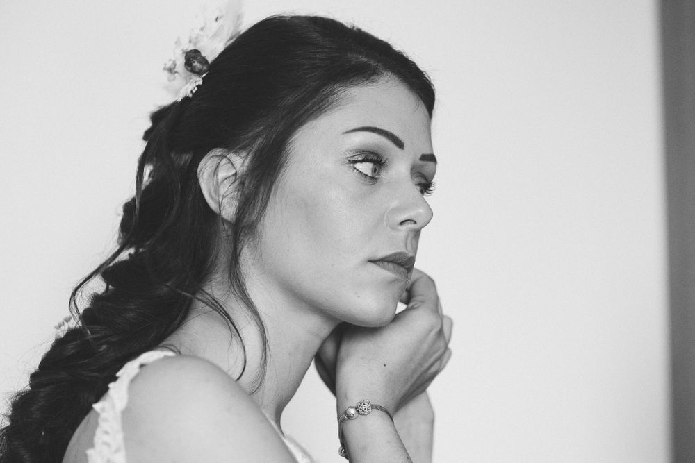 Artistic black and white portrait capturing a contemplative side profile pose.