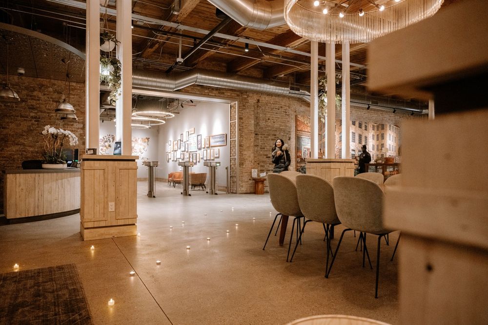Modern restaurant interior with wooden accents, exposed brick walls, and elegant pendant lighting illuminating the dining space.