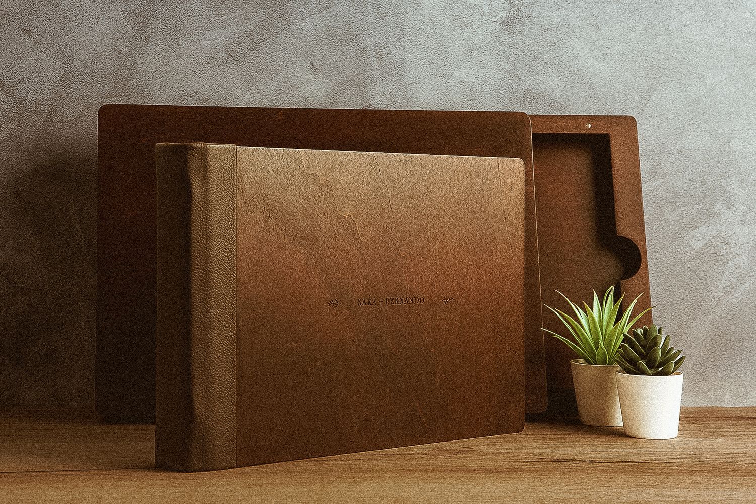 A modern wooden cutting board with geometric design stands on a wooden surface next to small potted succulents.