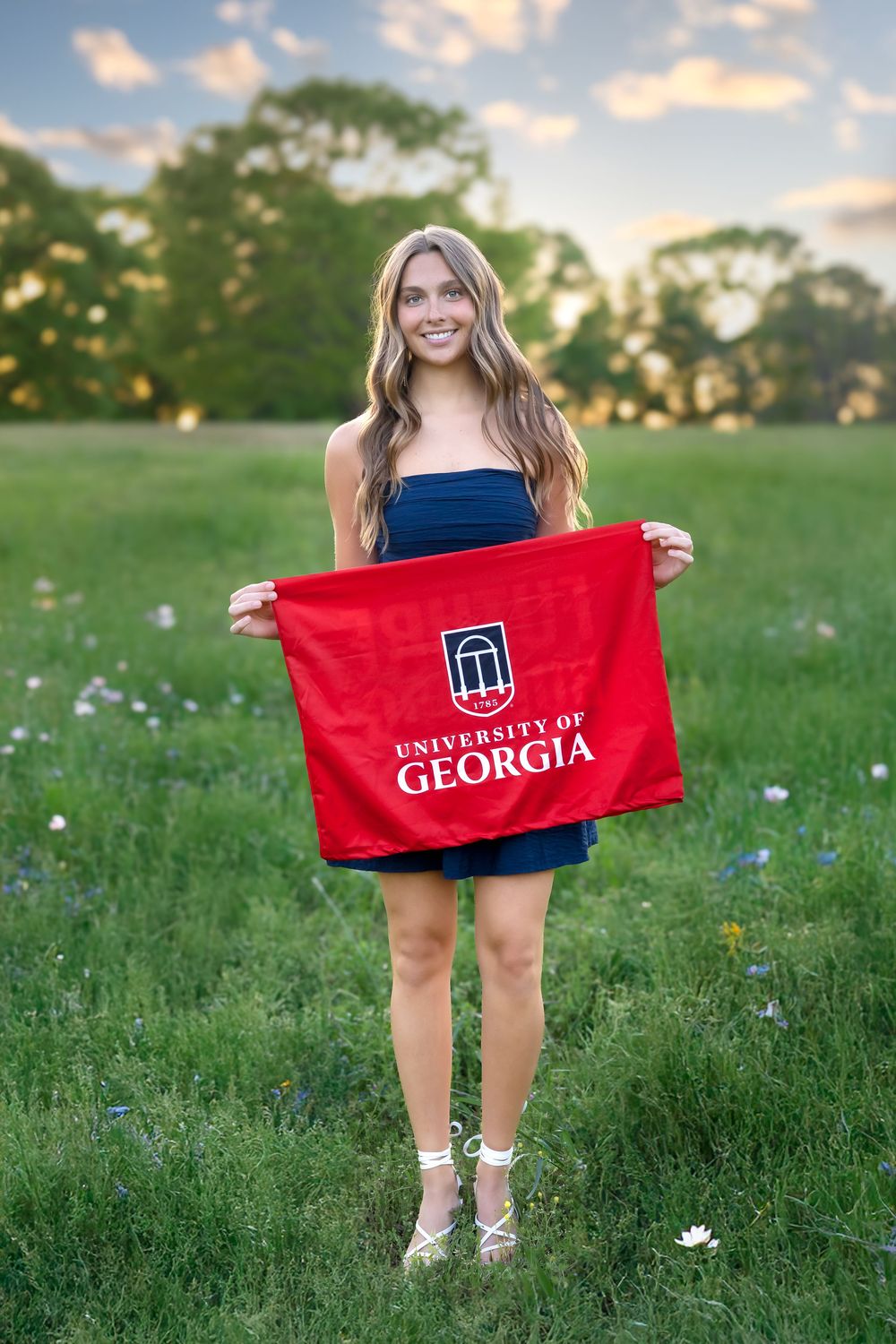 Oconee County senior posing for cap and gown photos during golden hour session in Athens, GA.