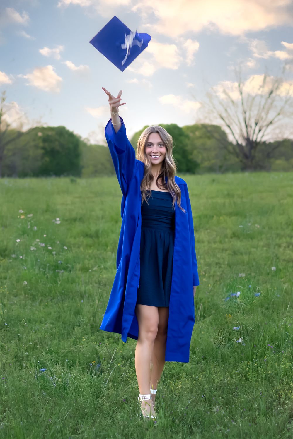 Graduation portrait of Oconee County High School senior throwing cap in the air during Senior photography session in Athens, GA.
