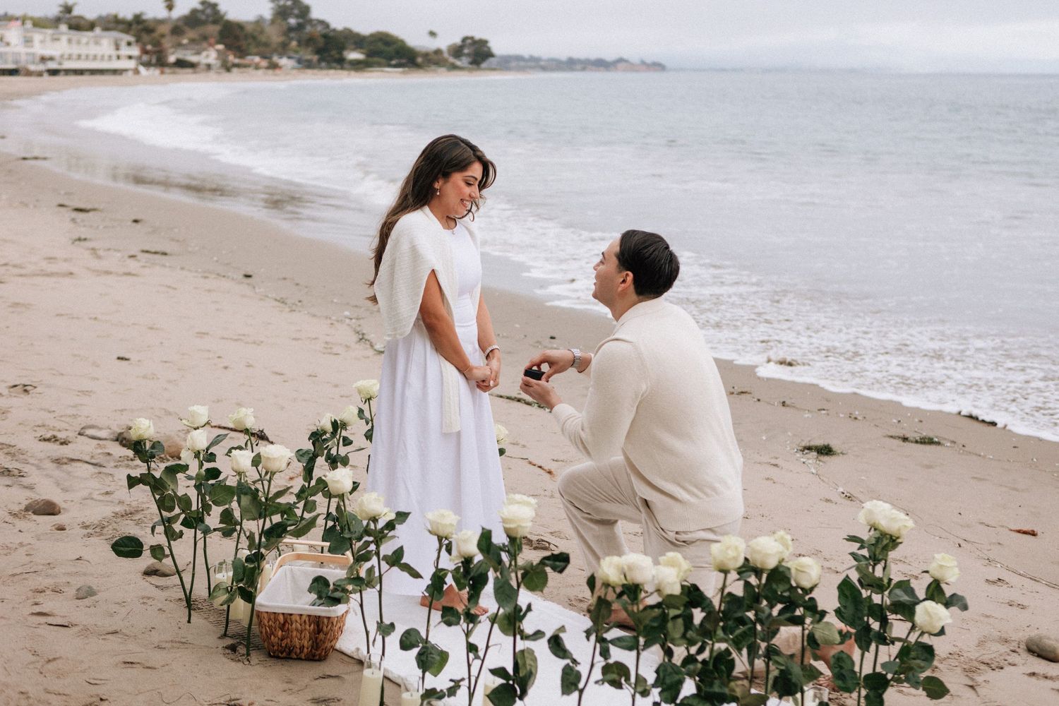 Hector down on one knee proposing at the beach in Montecito.