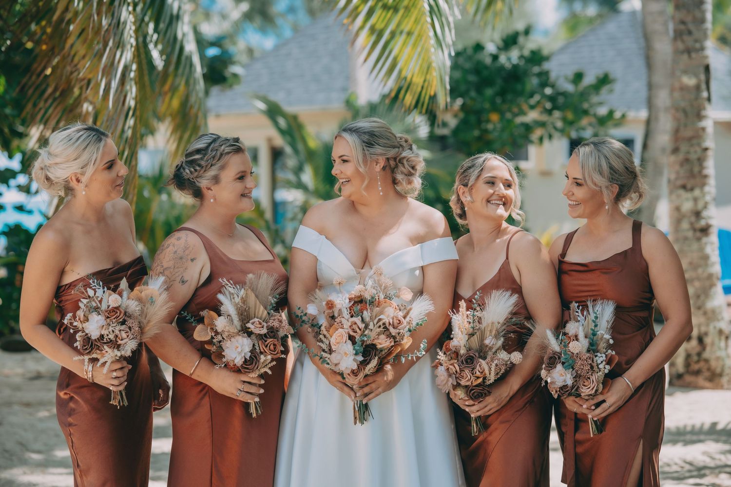 A couple embraces outdoors in golden sunlight while sharing their intimate wedding ceremony in a wooded setting.