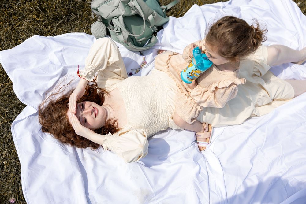 Multiple photos show individuals resting peacefully on white bedding in ethereal natural sunlight.
