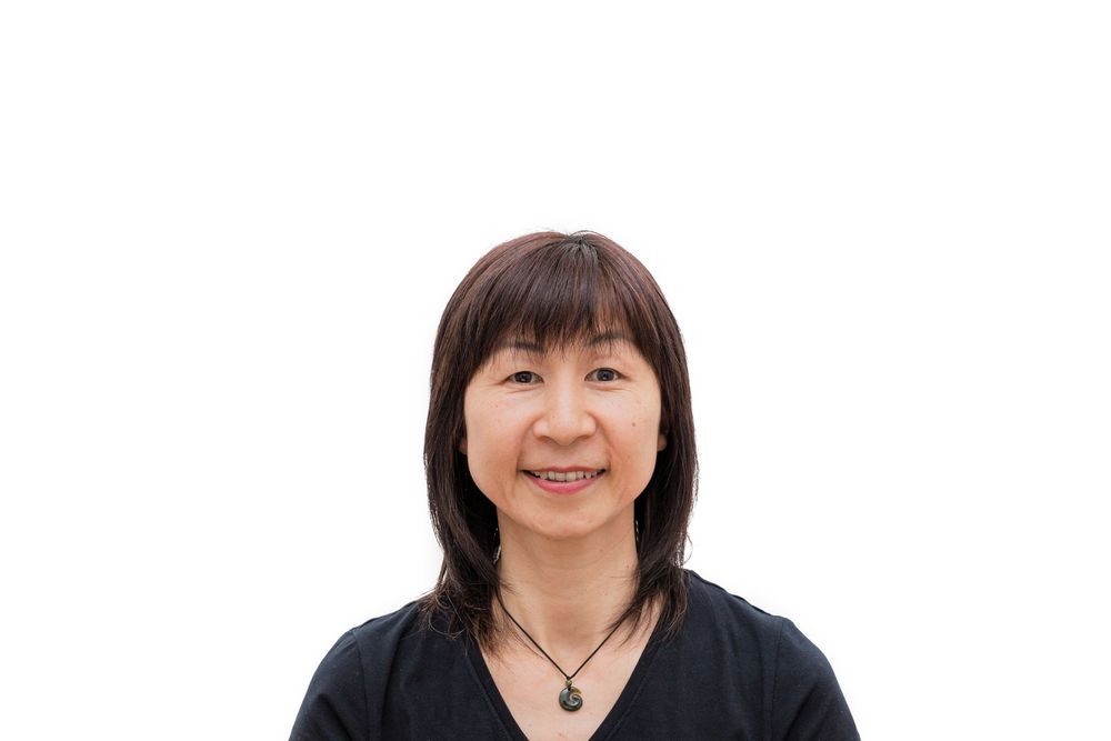 Portrait of person wearing black shirt against white background.