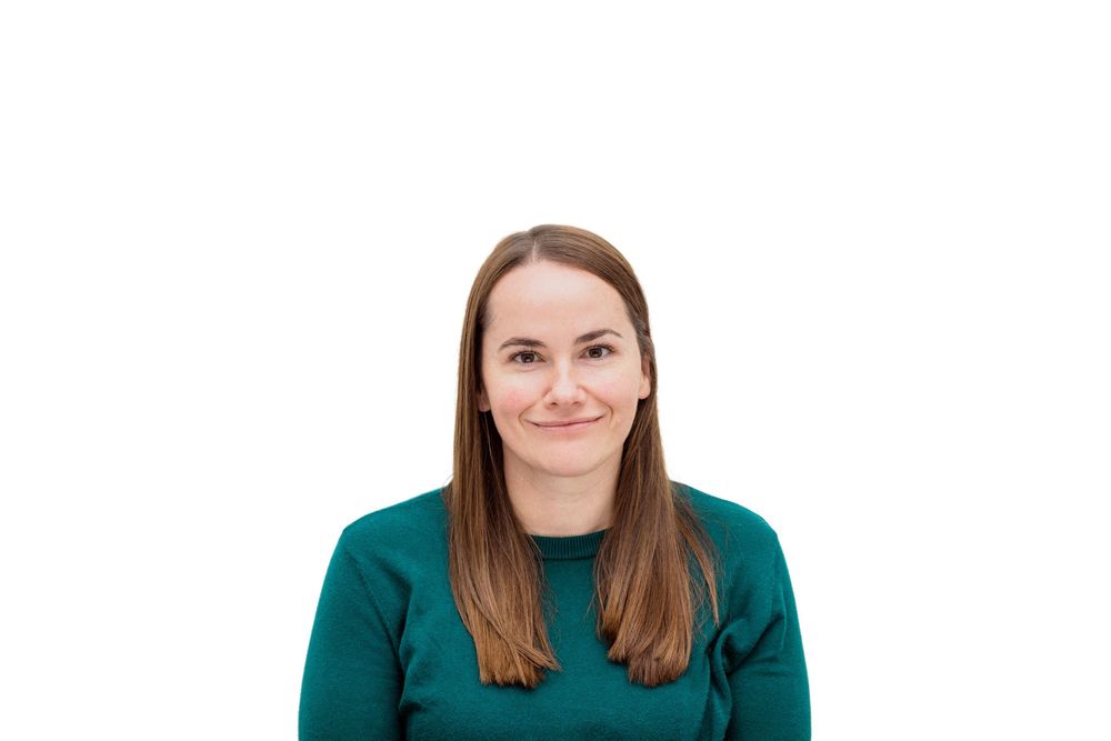 Portrait of person in green sweater against white background.