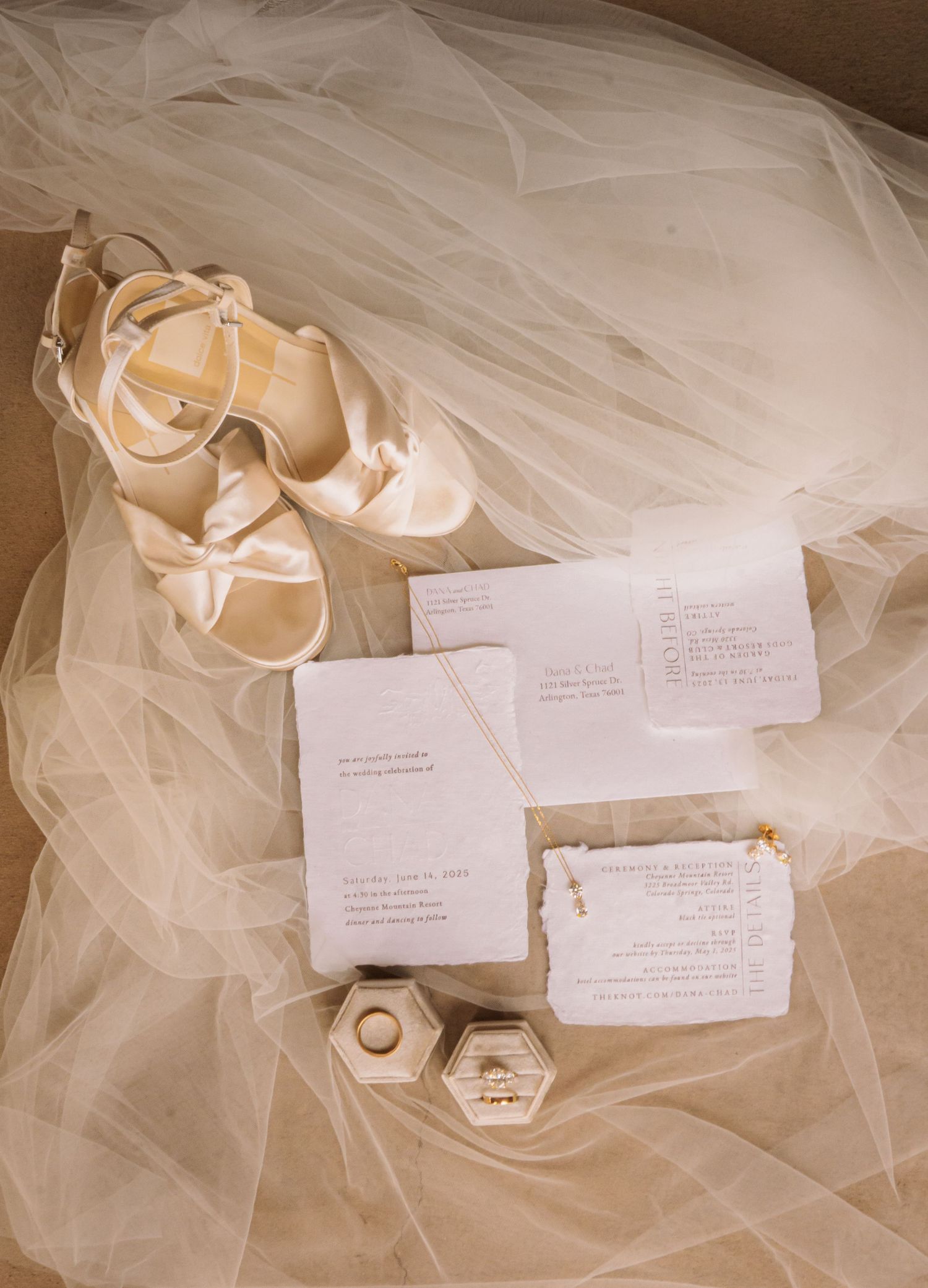 Colorado Springs Wedding Photographer. Photo of wedding decor with invitations, and bride's jewelry, shoes, and veil in a nice display.