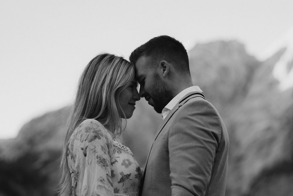 A series of intimate wedding photos in black and white showing romantic moments between a bride and groom.