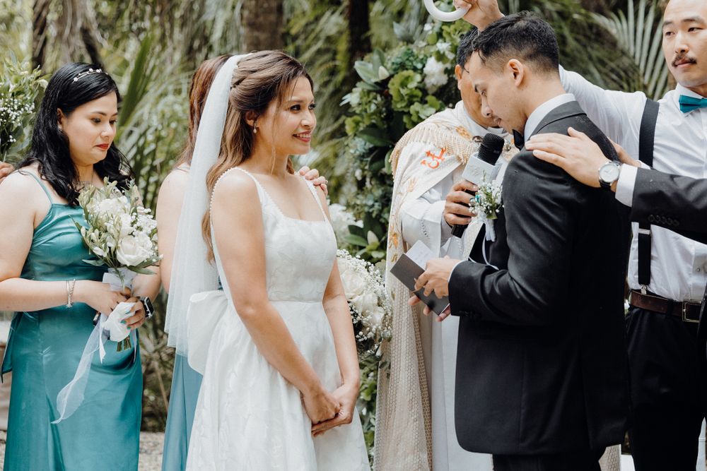 Joyous laughter fills the air during an outdoor wedding ceremony captured by Apertured Media Auckland Wedding Photographer.