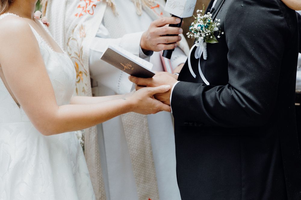 Close-up view of bride and groom exchanging vows during wedding ceremony captured by Apertured Media Auckland Wedding Photographer.
