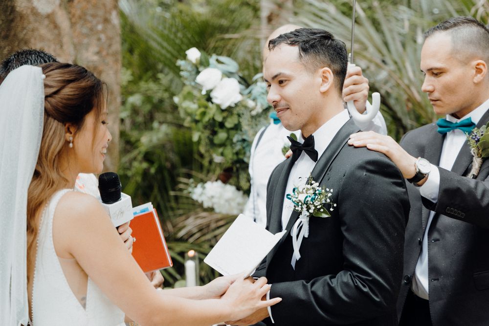A wedding ceremony takes place outdoors captured by Apertured Media Auckland Wedding Photographer.