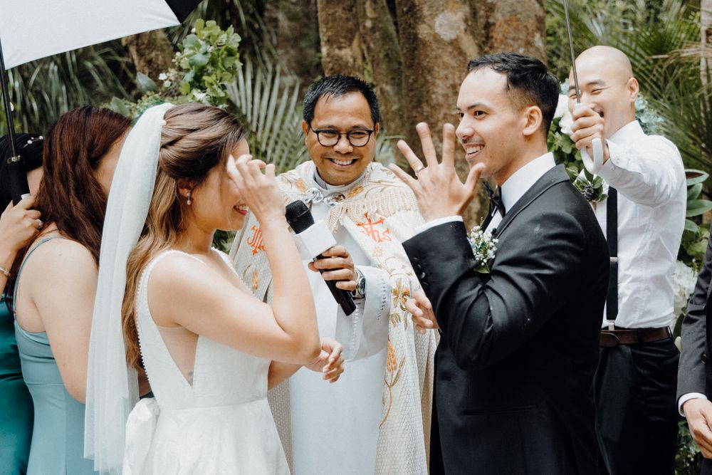A joyful moment of laughter shared among wedding party members captured by Apertured Media Auckland Wedding Photographer.