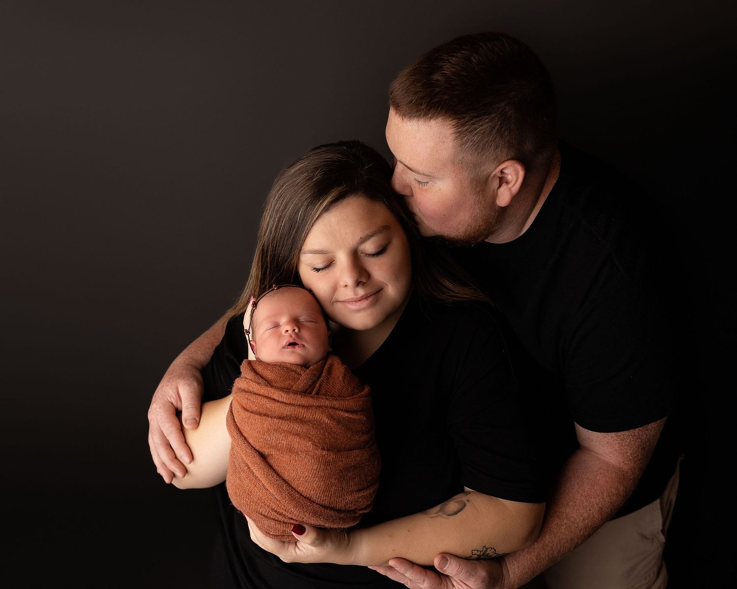 Professional photo of a newborn baby and her family
