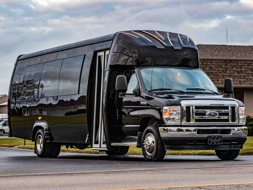 Sleek black Ford executive shuttle bus with panoramic windows and custom bodywork.