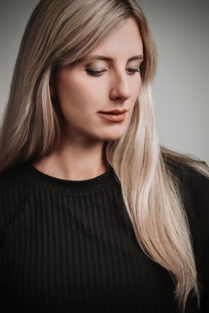 Subtle studio portrait featuring soft lighting and natural makeup.