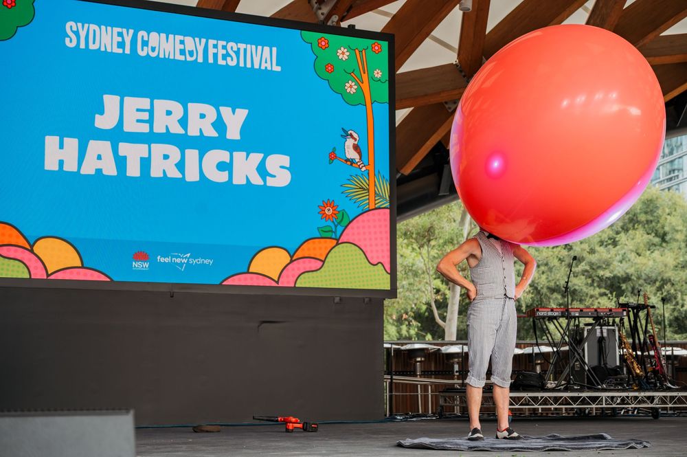 Jerry Hatricks performing on stage at Great Laugh in the Park, Tumbalong Park in Sydney © SIX84 Photography, Event Photography
