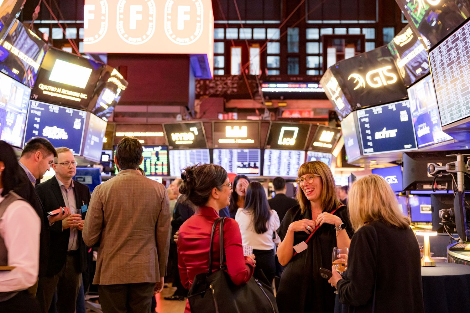 Professional photo of the FSuite event at the NYSE, capturing attendees in a dynamic, corporate setting