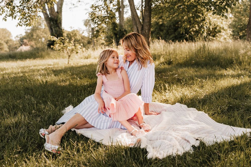 mom and daughter sit together on blanket in cincinnati, ohio