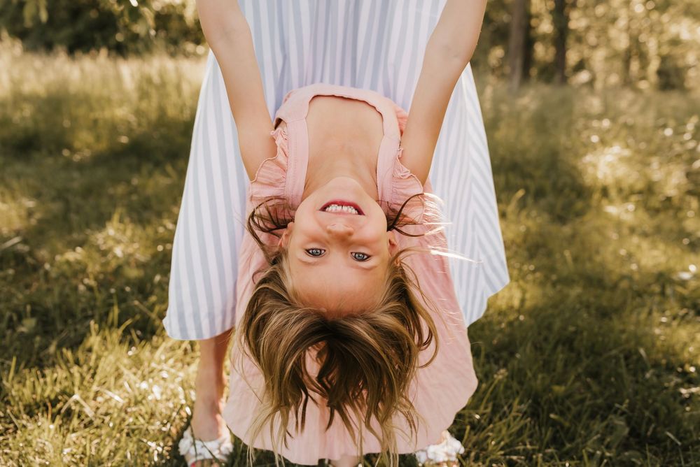 girl spins upside down and smiles big