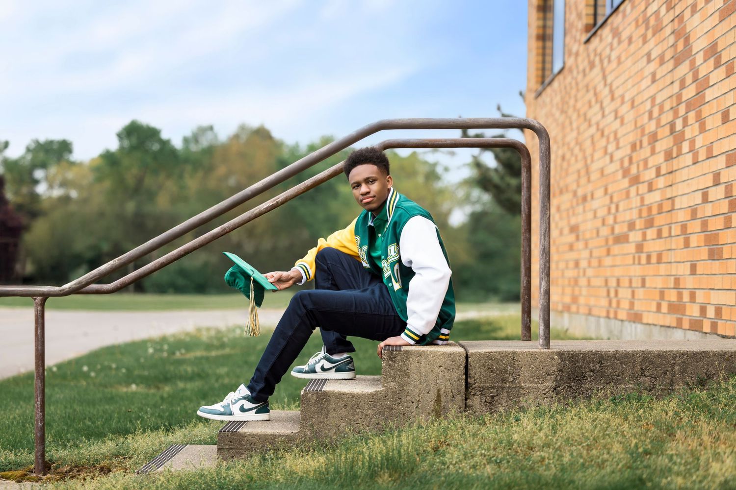 Candid senior photo with big smile and relaxed pose during Southwest Michigan session