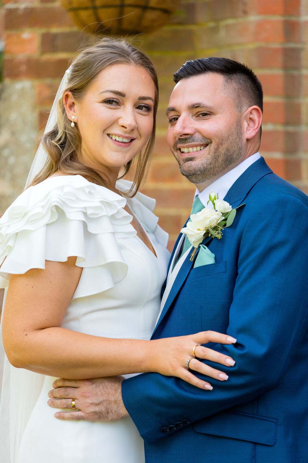 Louisa and Alan smiling and embracing outside Audley's Wood Hotel