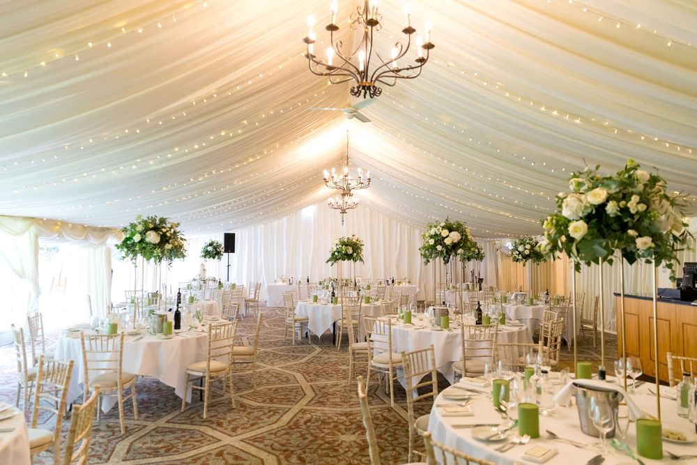 Elegant wedding reception setup with floral centrepieces and fairy lights