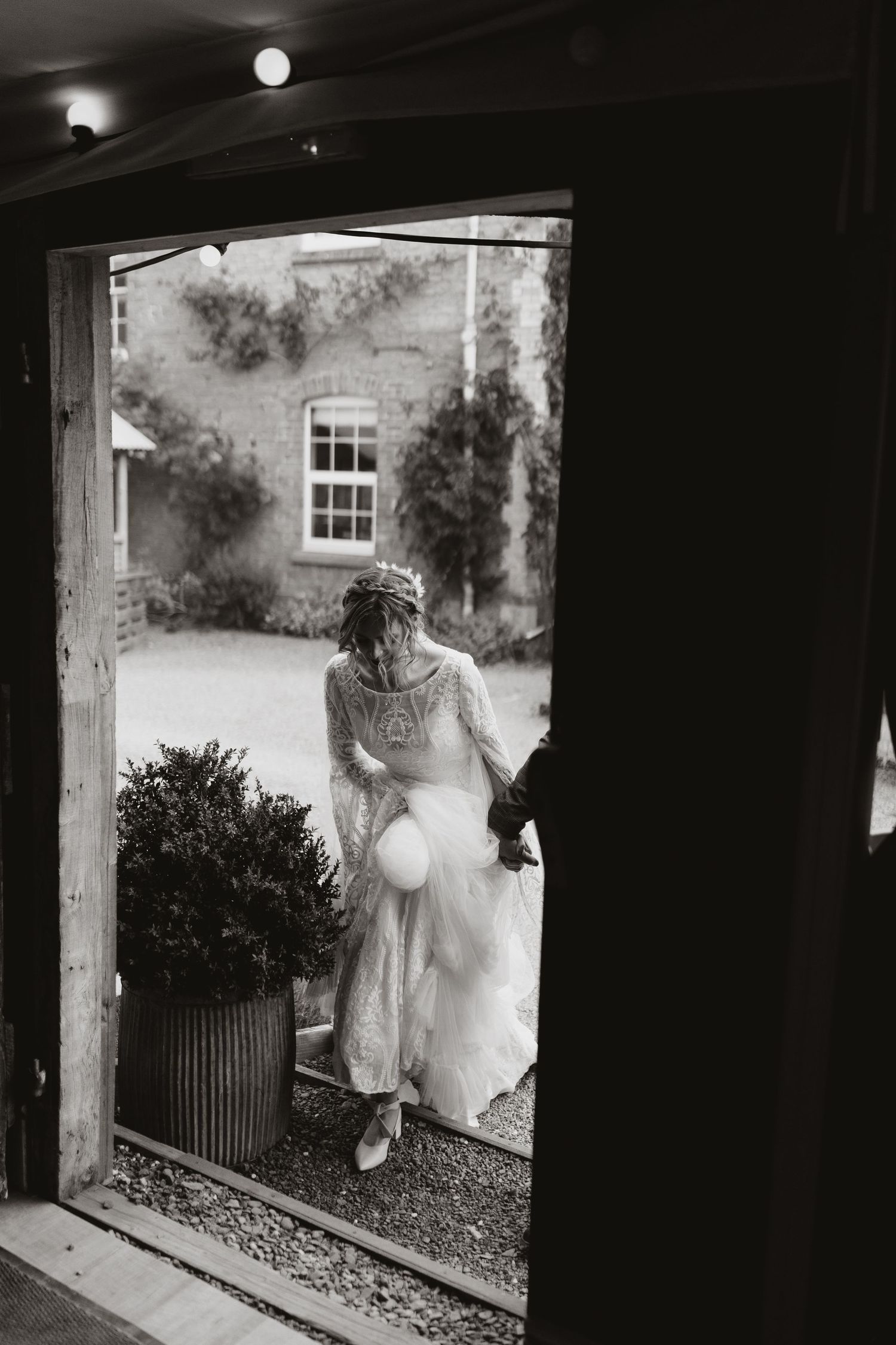 Four black and white photographs show an ethereal figure in a white dress appearing through dark doorways at night at Wilde Lodge.
